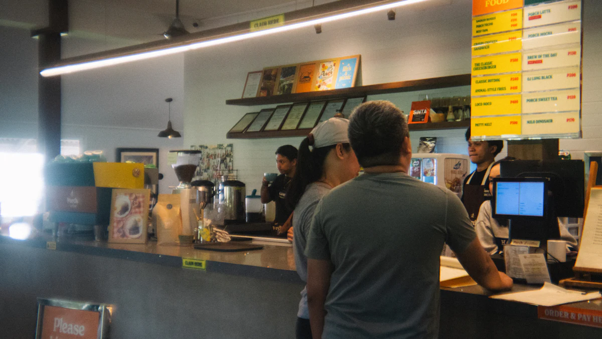 Customers ordering from staff at a café counter.